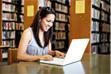 Photo of a woman using a laptop Photo of a woman using a laptop