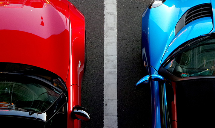 Red car next to a blue car