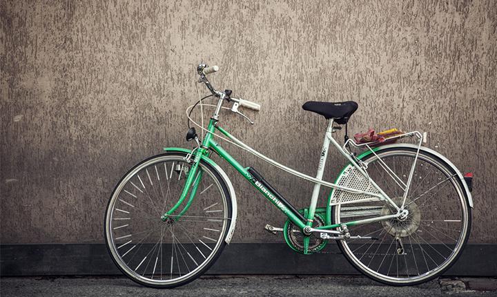 An old-fashioned green and white push bike