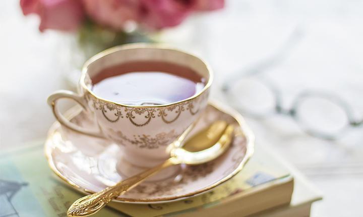 A china teacup with shiny gold spoon