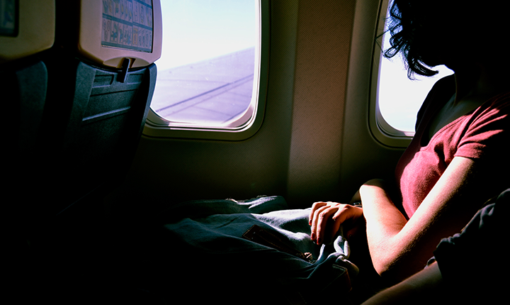 a woman looking out the window from an airplane
